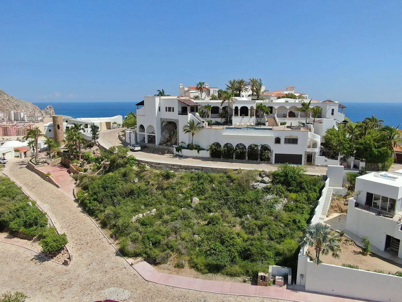 Modern homes for sale in Pedregal overlooking Cabo Marina with luxury terraces and panoramic ocean views