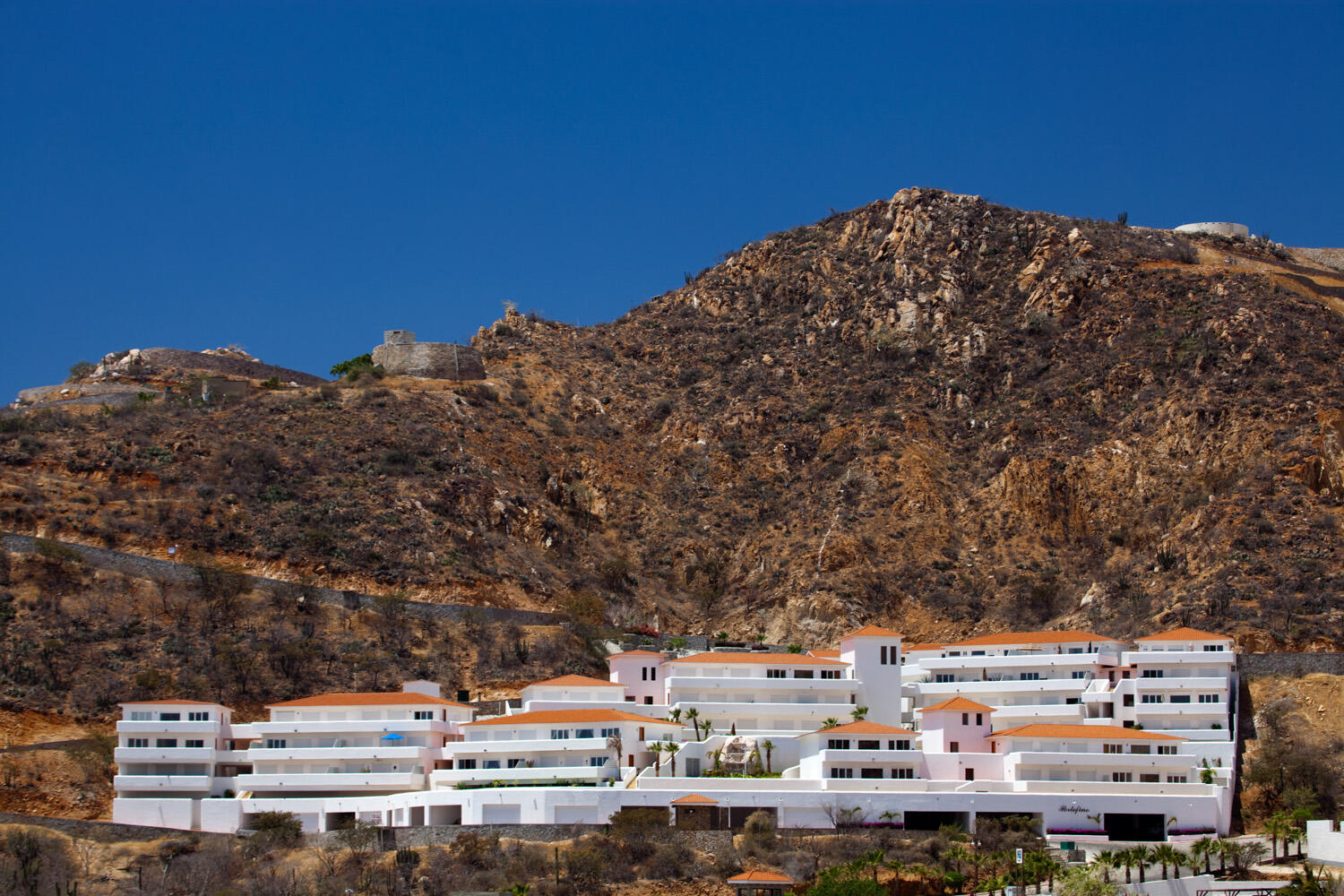 Pedregal The Five FIRE SALE!!!! Turn key, ready to move in!!Discover unparalleled elegance in this sophisticated 2-bedroom, 2.5-bathroom corner condo, perfectly situated in the prestigious Pedregal community. Step into a beautifully appointed interior, where spacious open-concept living meets breathtaking finishes. The kitchen boasts premium appliances, sleek countertops, and elegant cabinetry, perfect for entertaining or intimate gatherings. Each bedroom is a private sanctuary, featuring en-suite baths with high-end fixtures and luxurious details, the building also offers elevator for the residents convenience. The condo also offer its private terrace, pet friendly Access to all Pedregal Amenities: Including the renewed Spa, Restaurants, Tennis Courts, Beach, walking distance to International School "El Camino".Marina, Restaurants and all Cabo attractions are only 10 minutes walking. The condo comes fully furnished and decorated, that includes mexican pieces of art, paintings, black out curtains in all bedrooms and living area, parota furniture in terrace, (only a few personal items will be removed).Escritura, easy to close. – 85 Pedregal Camino Bonito Oriente, Cabo San Lucas, BS